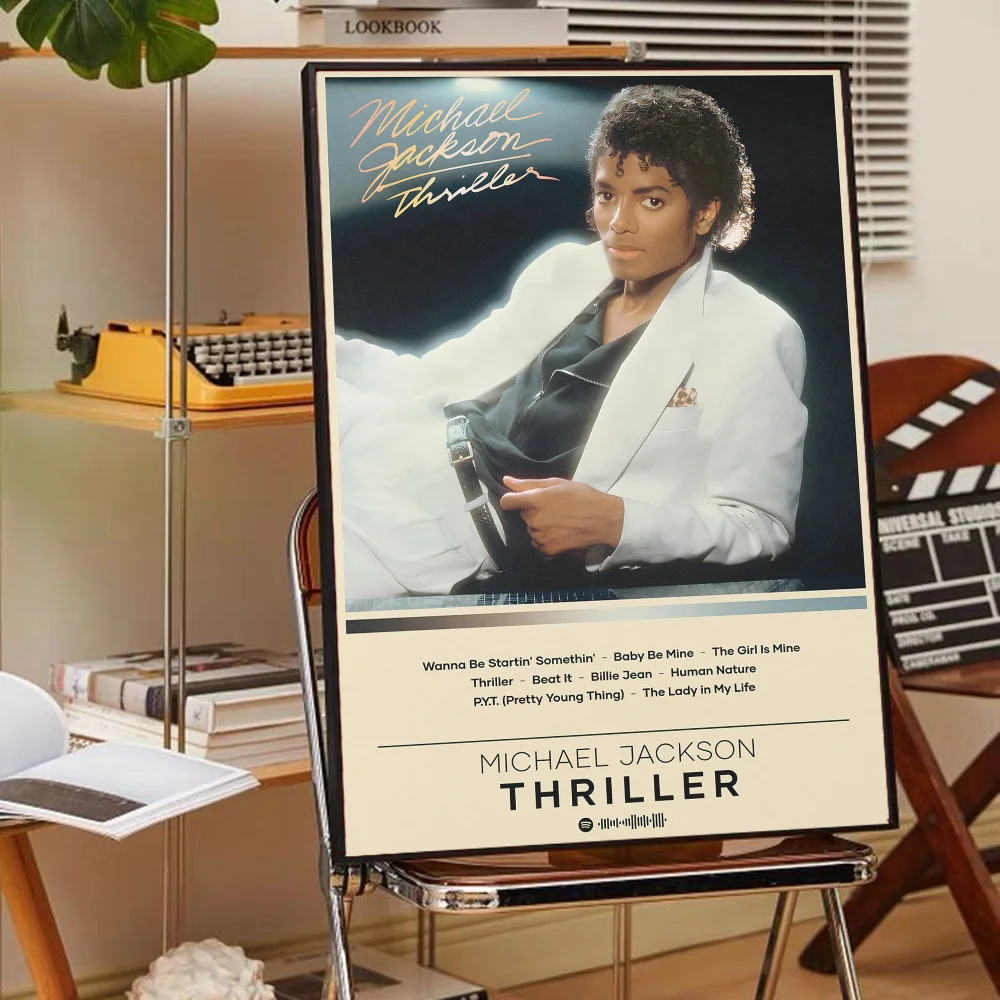 A framed poster of Michael Jackson titled Thriller featuring a portrait of the artist in a white jacket.