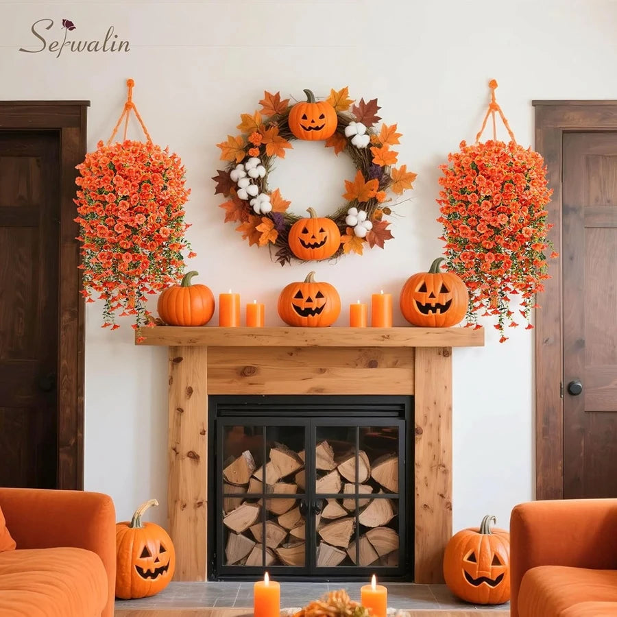 An orange pumpkin wreath decorated with autumn foliage hangs on a white wall above a fireplace.