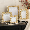 A set of gold-framed photo frames with white mats and a heart for you message displayed on a dark surface.