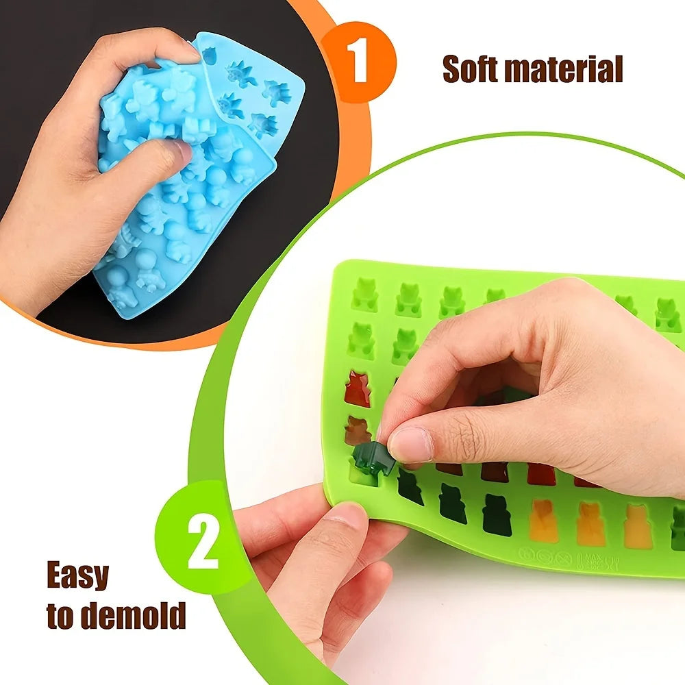 A hand is using a blue silicone mold to drop colored material into a green grid for DIY candies.