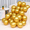 A cluster of shiny gold chrome metallic balloons arranged on a white cloth.