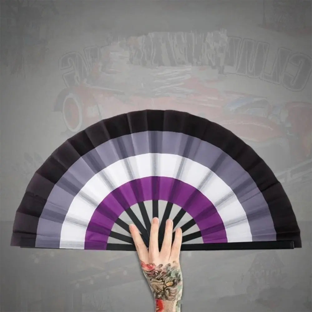 A hand is opening a colorful folding hand fan, showing the fan's pleated design.