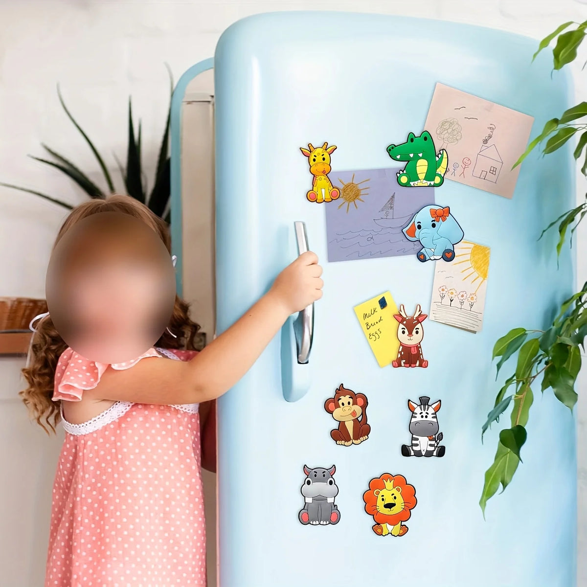 A young girl is interacting with a light blue refrigerator decorated with cartoon animal magnets.