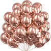 A cluster of metallic rose gold balloons tied together for party decorations.