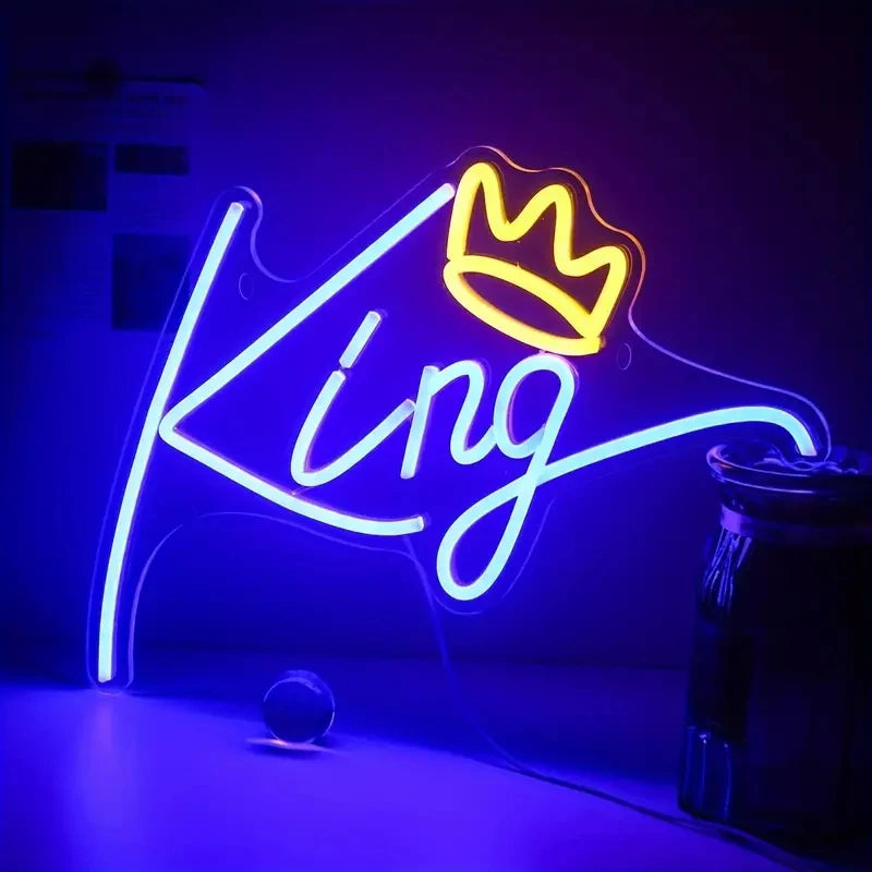 A neon sign shaped like a crown with the word King glowing bright blue on a dark background.