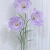 A large artificial silk purple poppy flower displayed on a green stand against a white background.