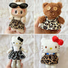 A collection of handmade leopard print shoulder strap skirts for dolls, including a brown teddy bear and a white cat doll.