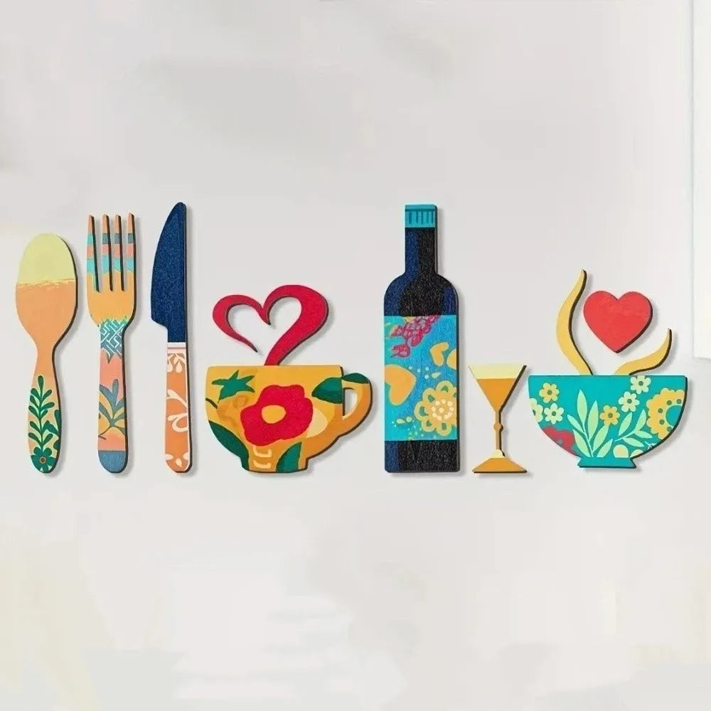 A set of colorful wooden kitchen decor including a spoon, fork, knife, teacup, bottle, and glass with floral designs.