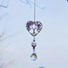 A hanging crystal tree of life sun catcher featuring purple crystals and a clear pendant.