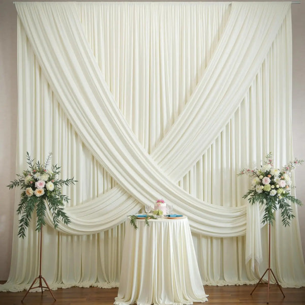 A cream colored, pleated polyester backdrop curtain draped in an 'X' shape for events and photography.