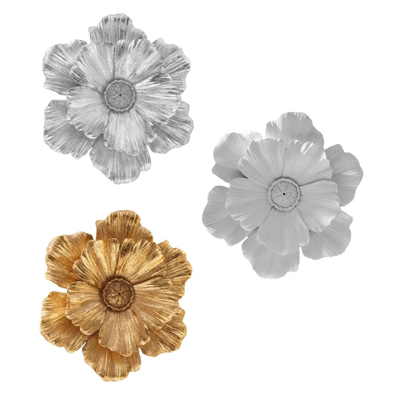 Three layered resin floral wall decor pieces in silver and gold tones.