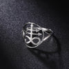 Silver signet ring featuring a Leviathan cross design resting on a dark, textured surface.