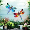 Vintage dragonfly wall art sculpture with iridescent blue and orange wings displayed against a light blue wooden fence.