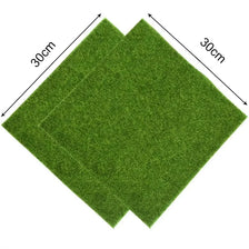 A rectangular artificial grass mat, approximately 30cm by 30cm, shown from above.
