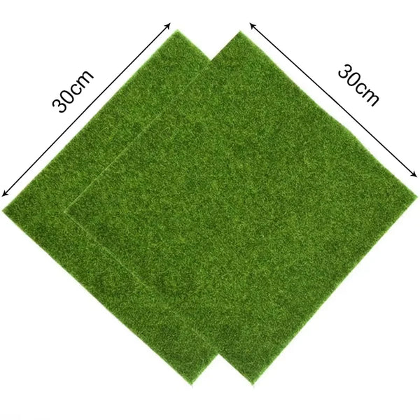 A rectangular artificial grass mat, approximately 30cm by 30cm, shown from above.