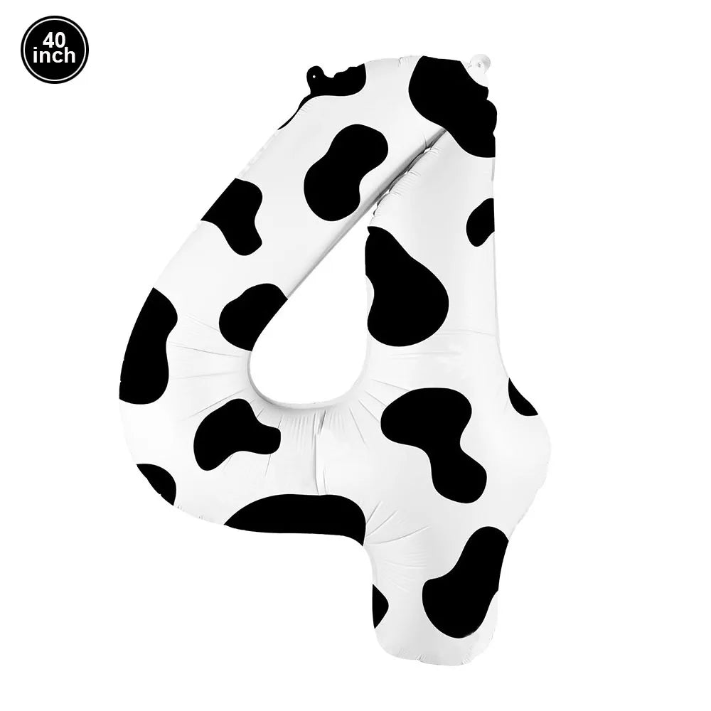 A white foil balloon shaped like the number 40 with a black cow print pattern.