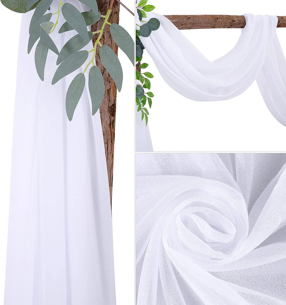 White chiffon wedding arch draping fabric panels with green foliage accents