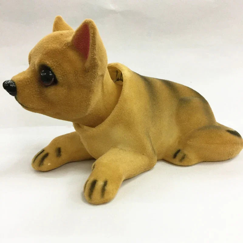A tan and striped dog ornament figure lying down.