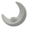 A modern, white, moon-shaped decorative vase with a small opening at the base.