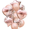 A collection of rose gold and pink latex and foil balloons shaped like stars and hearts.