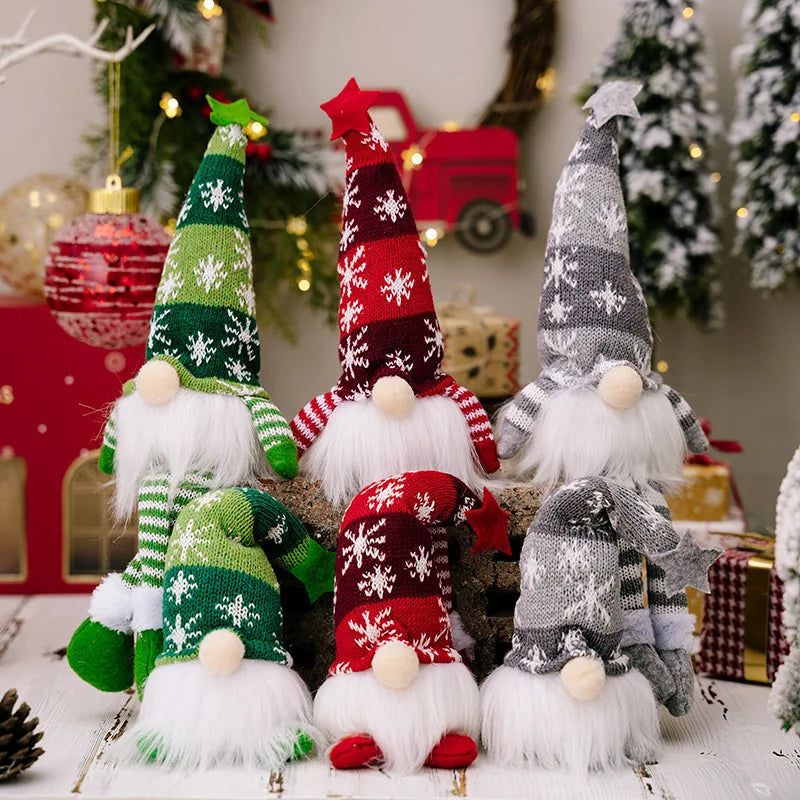 Three festive knitted gnome decorations with white beards and red accents displayed on a white surface.