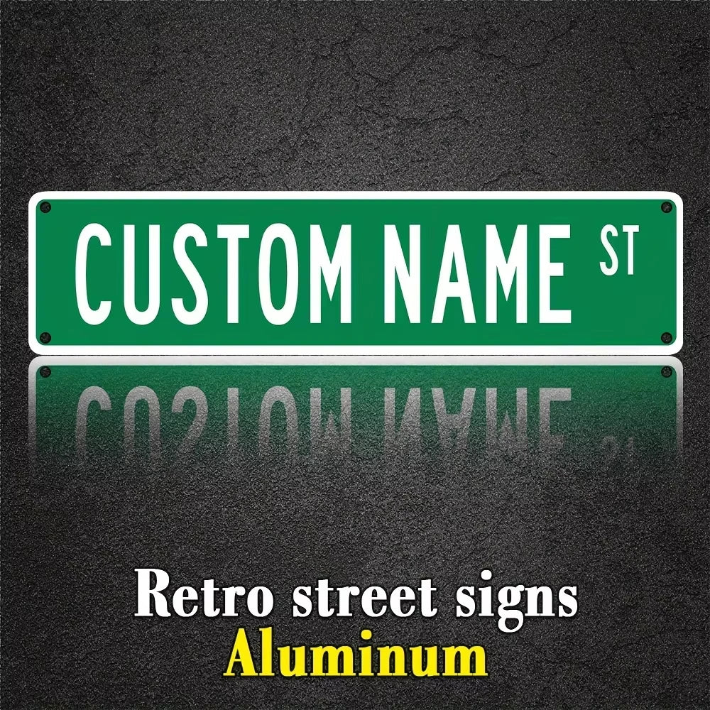 A green aluminum street sign with the text CUSTOM NAME ST mounted on a dark surface.