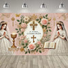 A soft pink First Communion backdrop featuring floral designs, a cross, and two girls in white dresses.