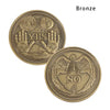 Moneda conmemorativa de bronce que presenta una señal de 'sí' y una mano esquelética para 'no'