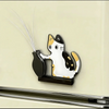 A black and white acrylic cat head decor featuring long, silver whiskers mounted on a wall.