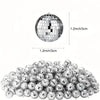 A pile of silver disco mirror balls used for party decor.