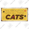 A rustic wooden plaque with yellow background and brown text that reads Yes I really do need all these cats