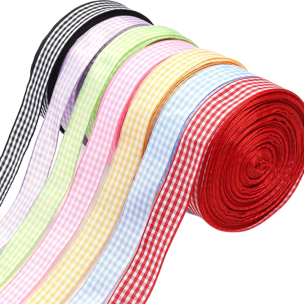 A roll of colorful gingham ribbon in various pastel and bright colors, including pink, yellow, green, and red.