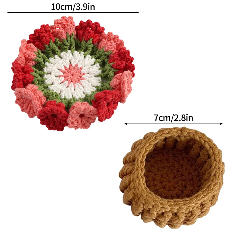 Hand-crocheted rose flower coasters featuring red, white, and green yarn in a circular pattern.