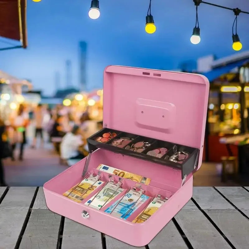 A pink lockable metal cash box is open, displaying an organizer tray with various currency bills inside.