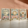 A set of three framed celestial tarot art prints featuring the moon sun and star with floral designs.