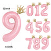 Pink aluminum foil crown number balloons showing the numbers 0, 1, 2, 3, 4, 5, 6, 7, 8, and 9.