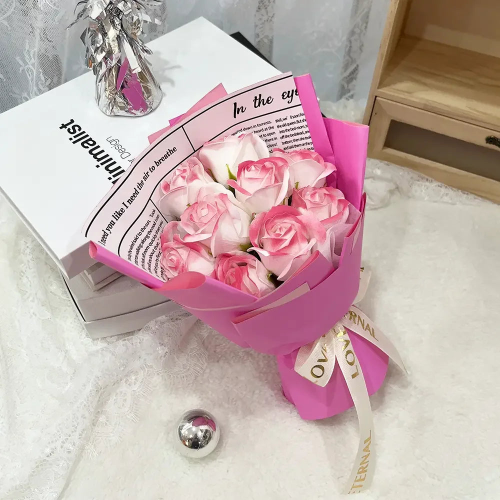 A bouquet of pink artificial roses wrapped in pink paper and tied with a ribbon sits next to a book titled Minimalist.