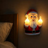 A glowing Santa Claus night light depicting a bearded man in a red suit making a middle finger gesture.