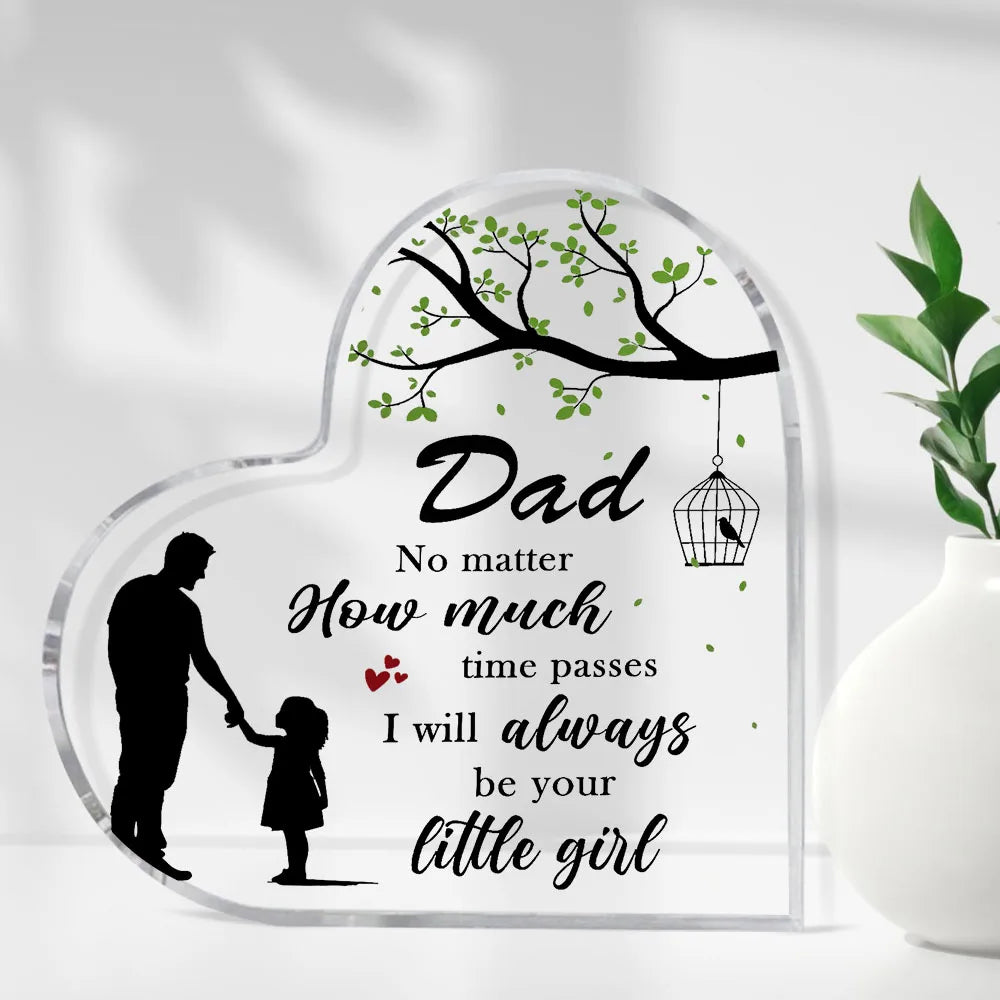 A clear acrylic heart-shaped plaque engraved with the text "Dad No matter how much time passes I will always be your little g