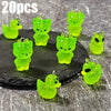 20 pieces of glow-in-the-dark green cartoon alien kitty duck resin charms displayed on a dark surface.