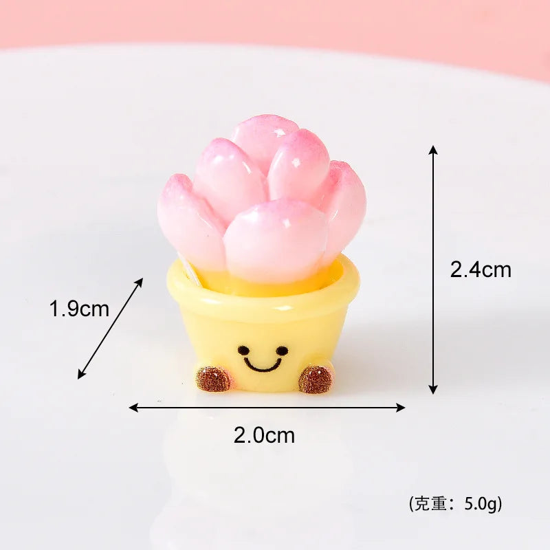 A small yellow pot holding pink resin rose charms for crafting and dollhouse decoration