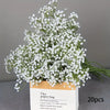 A bouquet of white baby's breath artificial flowers in a paper bag