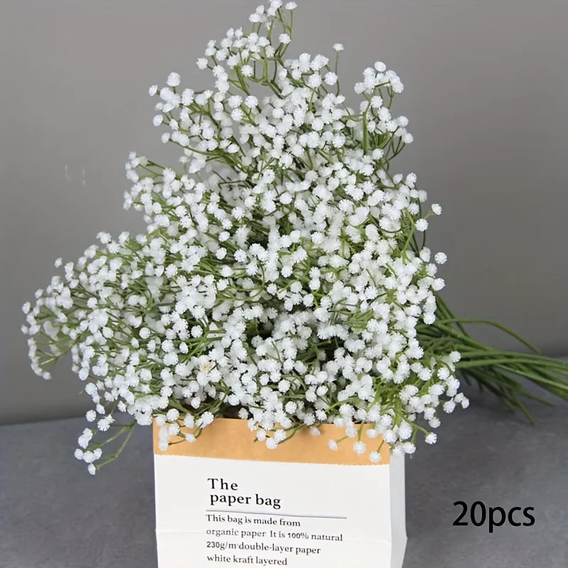 A bouquet of white baby's breath artificial flowers in a paper bag