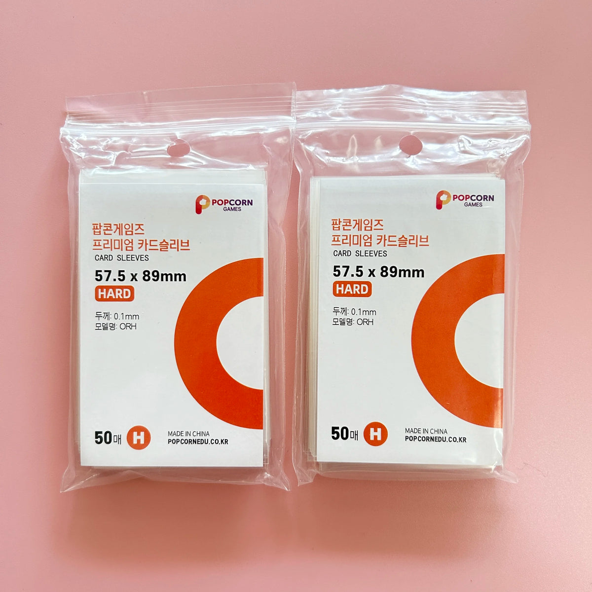 A pair of clear plastic bags containing 50 hard card sleeves for Pokemon games.