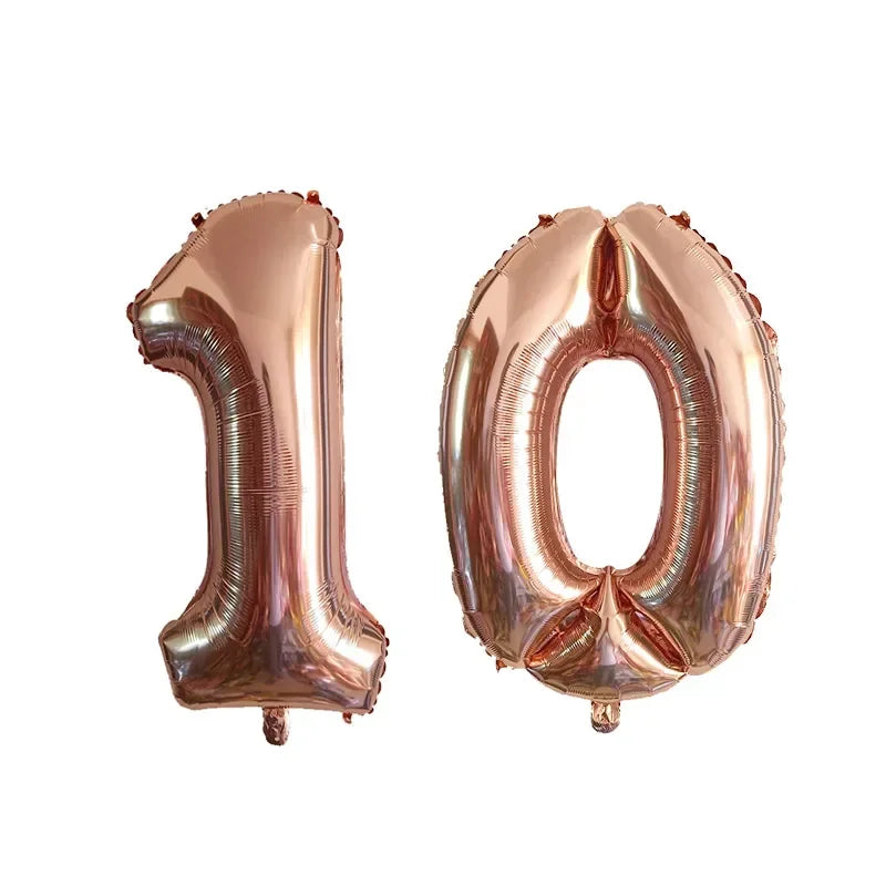 Two metallic rose gold foil number balloons shaped like 1 and 0