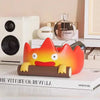 A resin cartoon fire person tray with orange and yellow coloring displayed on a white surface.