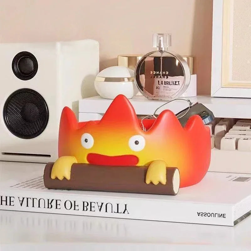 A resin cartoon fire person tray with orange and yellow coloring displayed on a white surface.