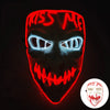 A glowing red mask with white text and bright blue eyes against a dark background.