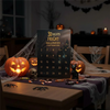 A dark wooden table displays a 31 Nights of fright countdown box with various Halloween-themed items like pumpkins skulls and