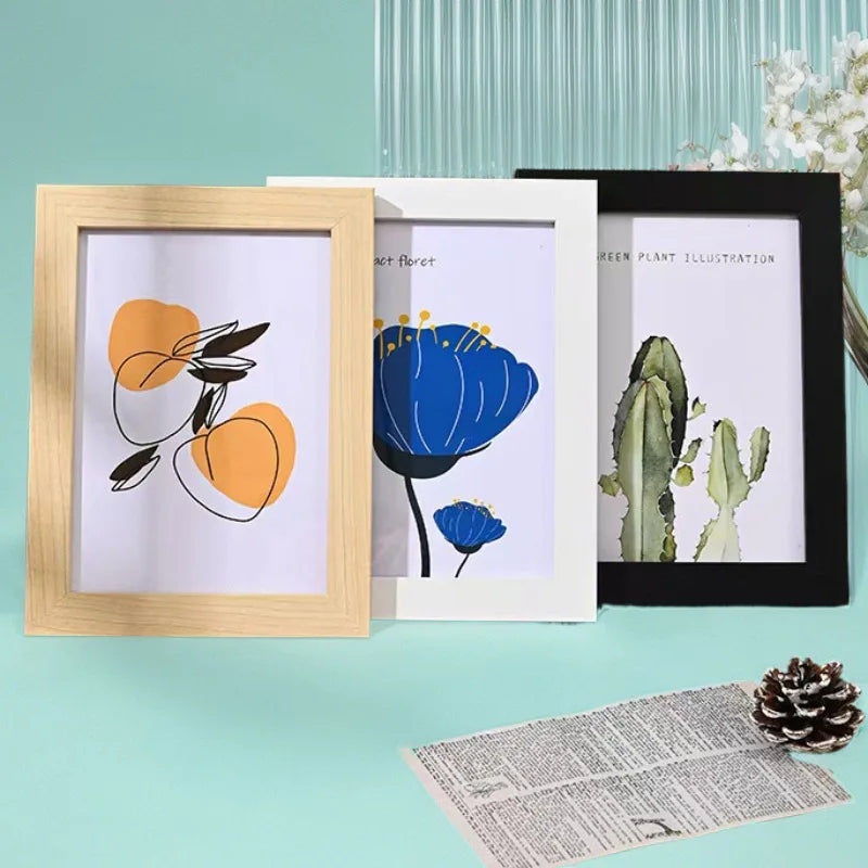 Three wooden photo frames display illustrations of leaves, flowers, and a cactus on a light blue background.